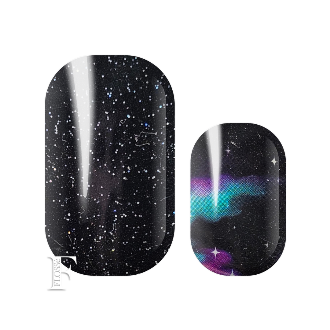 Flossé nail wraps alternating set featuring a black galaxy starfield nail wrap with fine sprinkle of holographic glitter, and accent nails with cyan blue, and purple swooshes of colour. New Zealand nail wrap stickers.
