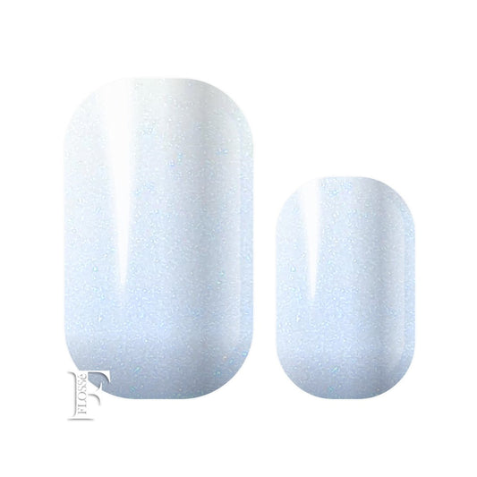 Pearlescent nail wraps with soft blue shimmer in sunlight.