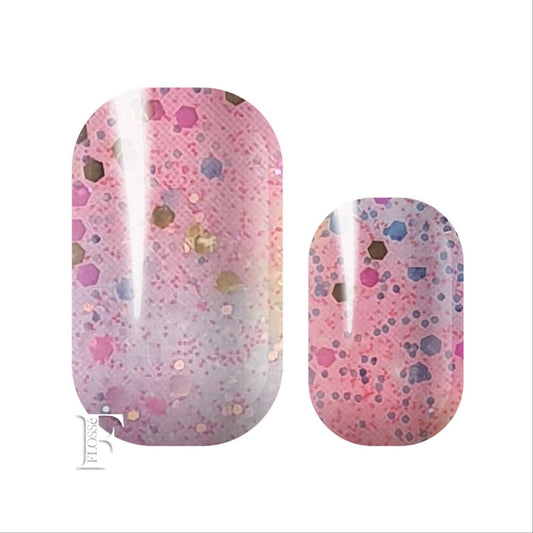 FLOSSé nail wraps of soft baby blue and pink, topped with gold glitter and sequins.