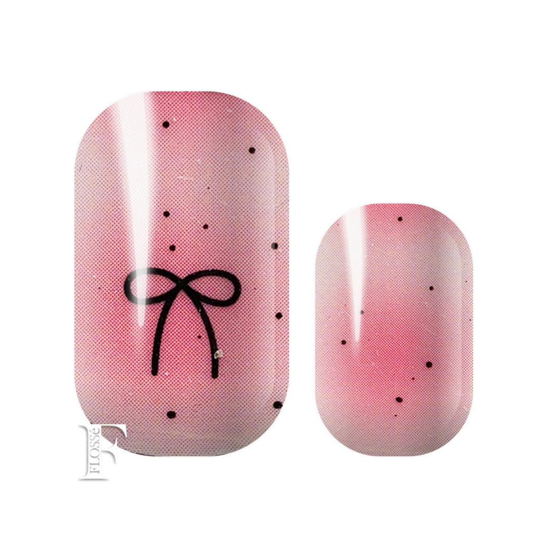 Alternating ombre pink nail wraps featuring a black bow graphic and small polka dots, alternating with ombre pink nail wraps with small polka dots. New Zealand nail wrap stickers. 