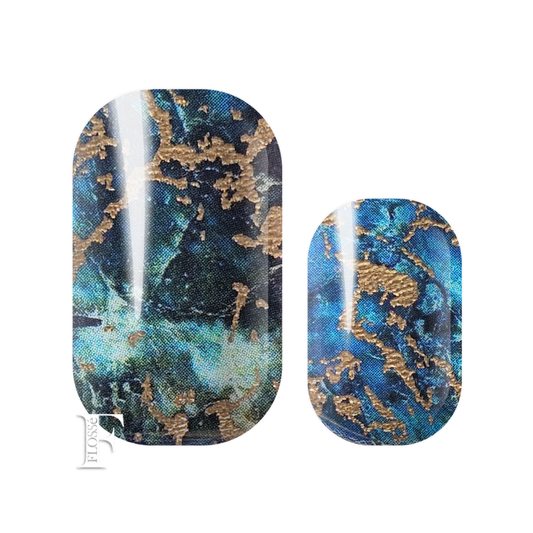 Flossé nail wraps showing a dark and stormy blue and teal marbled pattern with metallic gold veining. New Zealand nail wrap stickers. 