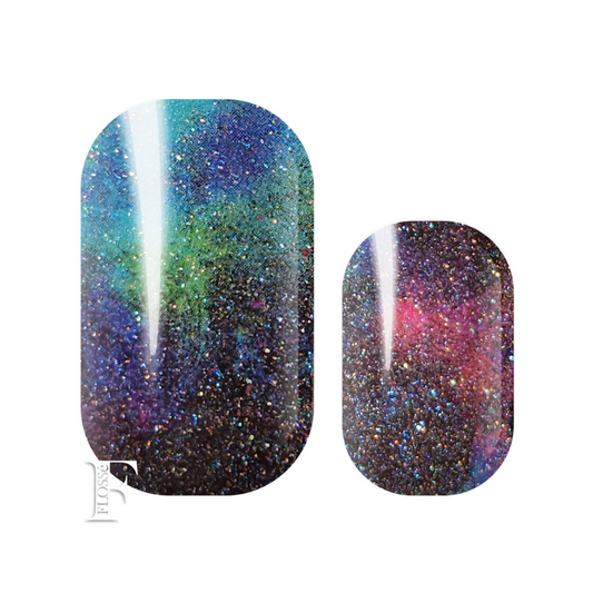 FLOSSé Jinxxed nail wraps. Dark moody pearl glitter nail wraps with mixed colours of purple, green, and blues. Topped with a holographic sparkle. 