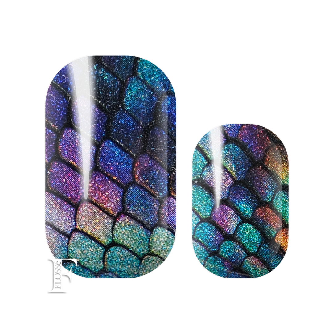 Nail wraps with an iridescent holographic scale pattern with purple, blue, green, and gold tones. Shimmering pearl glitter. New Zealand's nail wrap stickers. 