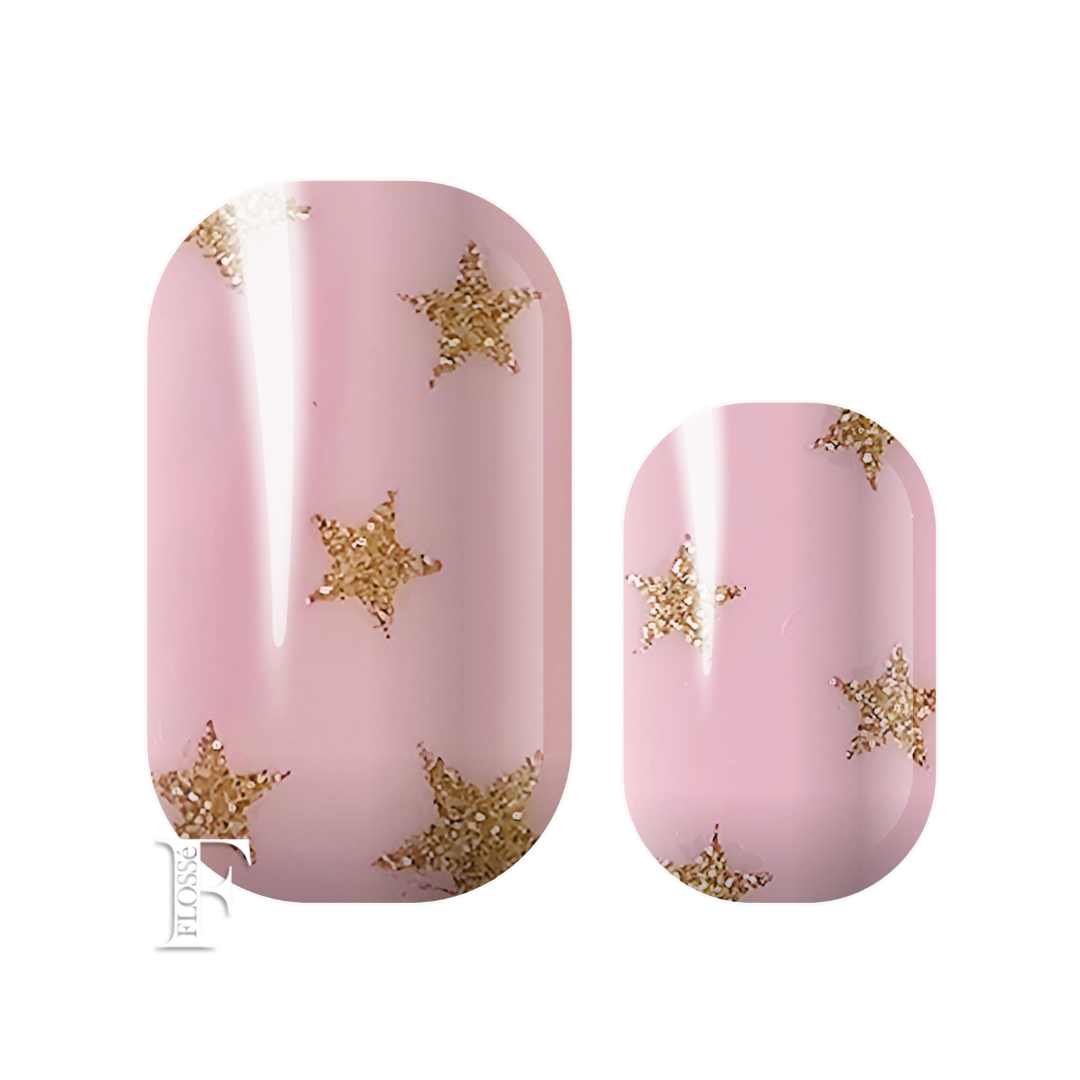 Flossé nail wrap featuring light pink block colour background with gold glitter star details. New Zealand nail wrap stickers. 