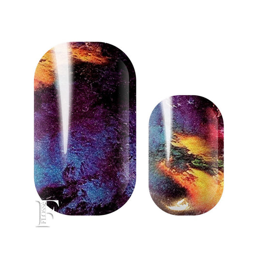 Dark stormy looking nail wraps with background colours of blue, black and purple with bright splashes of yellow and orange on top.