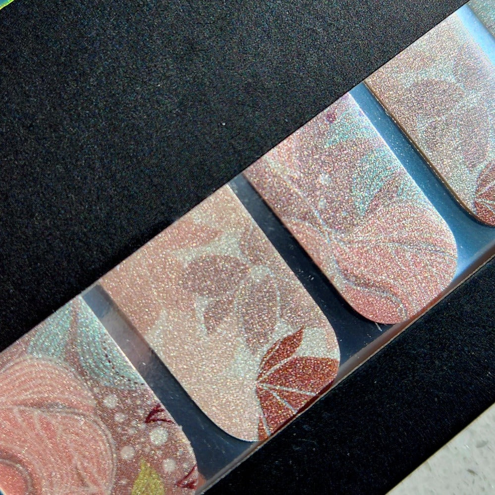 Close up view of Be-leafin FLOSSé nail wraps in packaging, showing pearl shimmer effect. 