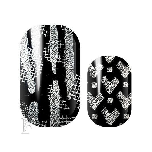 Black gloss nail wraps with silver glitter pattern details.