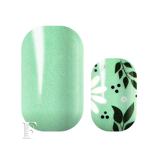 A fund pastel mint green overlaid with white daisies and green foliage. FLOSSé nail wrap nail stickers NZ.