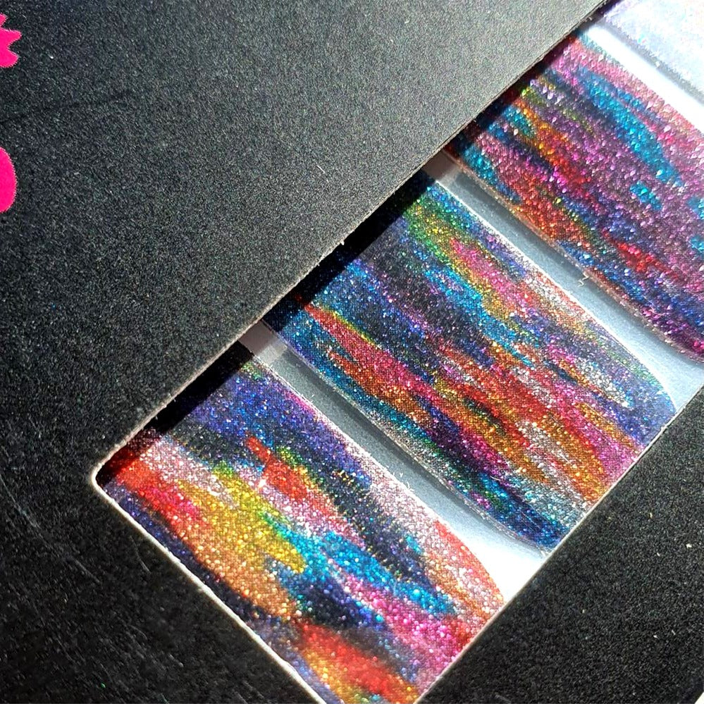 Close up looking at pearl sparkle effect of FLOSSé nail wraps Colour Run. Bright multi coloured glitter nail wraps