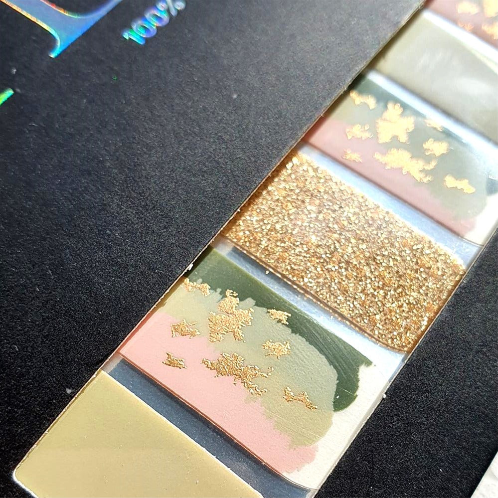 Close up of garden blush nail wraps showing gold foil detailing and gold glitter accents. 